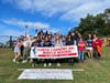 Students from Miller Place School District’s North Country Road Middle School gather together with their banner before marching in the parade.