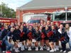 Miller Place High School’s varsity cheerleading team starts the parade at the Miller Place Fire Department.