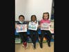 Students in Mrs. Hauff’s Kindergarten class at Deasy Elementary School proudly show off the cards they created for local veterans.