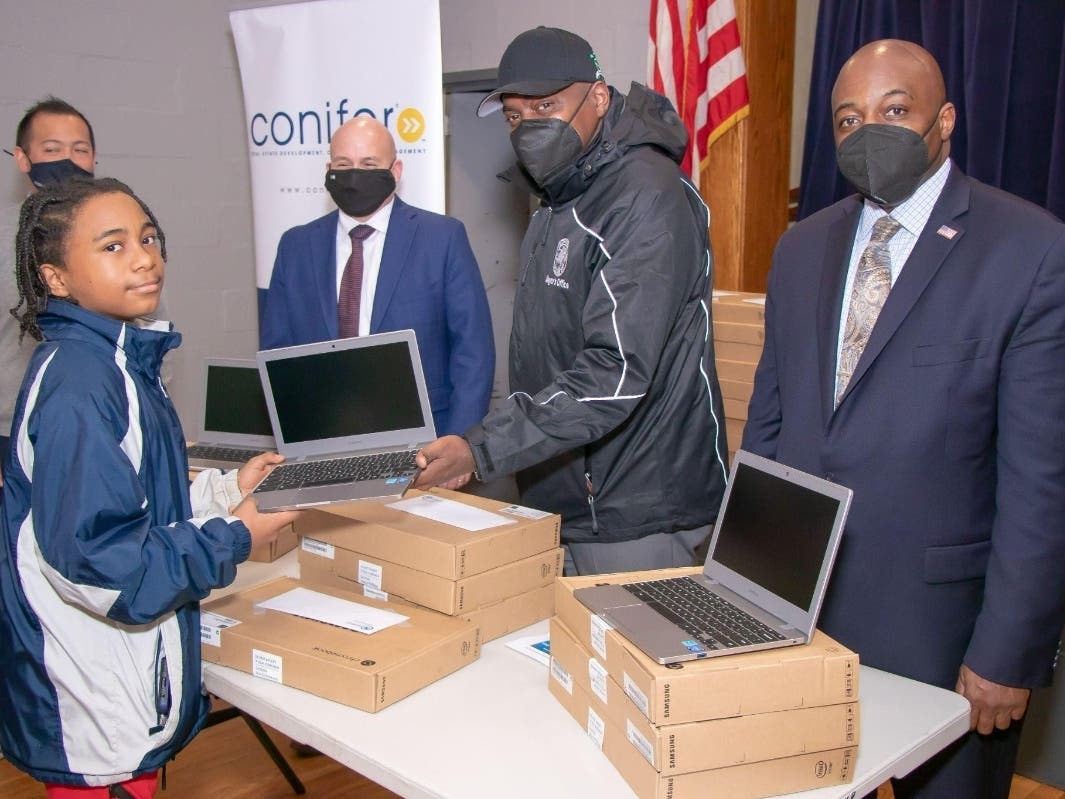 Bridge the Gap Initiative Participant Receiving one of the Laptops.
