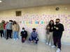 Lawrence Middle School students standing in front of their Wall of Kindness