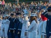 Students simultaneously moved their tassels across their faces to signify their commencement. 
