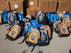 Backpacks ready to be worn by students