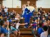 Pulaski Street Intermediate School students eagerly high five Rippy the Riptide