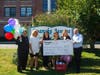 Roanoke Avenue Elementary School elementary specialist Lisa Nappe is presented with the check for the Tanger Grant by Tanger representatives