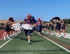 The Miller Place Panthers ran through a celebratory banner and onto the field as the high school cheerleading squad celebrated the first game of the season. 
