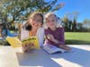 Two students read together on Outdoor Learning Day