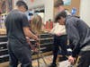 English language arts 10th grade students at Babylon Junior-Senior High School engaged in a series of hands-on, survival activities exploring the themes present in Lord of the Flies. Among the activities was shelter building; pictured.