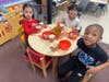 Lawrence Pre-K students practicing their chopstick skills