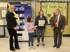 Third-grade student Hazel Kamath is given a chance to use the book vending machine. She is pictured here with Councilwoman Jane Bonner, left, PTO representative Dawn McCarthy and Miller Place Superintendent of Schools Mr. Seth Lipshie. 