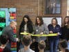 Miller Place Superintendent of Schools Mr. Seth Lipshie cuts the ribbon at the commemorative book vending machine ceremony. 