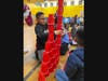 Lawrence young learners working together to stack the tallest tower