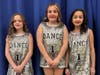 Students wore matching outfits for a dance routine. 