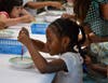 Through one STEAM activity, students experimented with the color wheel by mixing drops of different colored dyes into a bowl of milk and soap and creating new colors.    