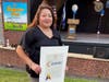 Adelina Blanco-Harvey holding her citation from County Executive Bruce Blakeman’s office on August 3.