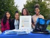 Adelina Blanco-Harvey holding her citation with the tabling team of Premier Endodontics of Long Island at the Salvadoran American Festival in Hempstead Lake Park on August 6.