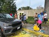 Students worked together with their families to wash cars for Valley Stream residents.