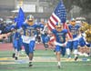 The Comsewogue High School football team ran onto the field for their homecoming game. 