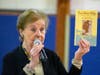 Holocaust survivor Marion Blumenthal Lazan holding her book Four Perfect Pebbles: A Holocaust Story