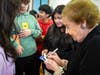 Holocaust survivor Marion Blumenthal Lazan signing autographs for Riverhead Middle School students and answering their questions