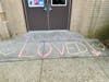 At William L. Buck School, students wrote positive messages in chalk on the entranceway to their school. 