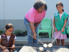 Photo 1: CEO Rande Bynum roasting s’mores with GSNC Brownie and Junior.