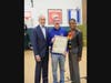 All Round Foods CEO Glen Wolther, center, is honored with a proclamation presented by Westbury Board of Education President and Town of North Hempstead Councilman Robert Troiano, Jr., left, and Nassau County Legislator Siela A. Bynoe, right