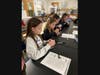 Sunrise Drive STRETCH students working on their DNA necklaces at Sayville High School.
