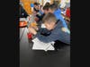 Sunrise Drive STRETCH students working on their DNA necklaces at Sayville High School.
