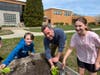 Tremont Elementary School Principal Dr. Christopher Kelly, middle, and two Tremont Elementary School students tend to the school’s garden beds.