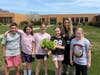 Tremont Elementary School students showcase fresh greens they grew.