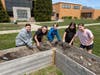 Tremont Elementary School students gain hands-on experience as they dig into a garden bed.