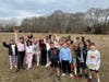 Tremont Elementary School students hold up fresh carrots.
