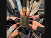 Members of the Patchogue-Medford High School Model UN team point to the Award of Distinction they won.