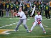 Patchogue-Medford High School quarterback Mackenzie Hughes, left, prepares to throw.