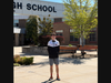 Patchogue-Medford High School senior Colin Jennings showcases the benches he replaced at the high school’s main entrances.