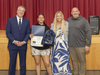 From left, LIRR President and Patchogue-Medford School District alumnus Robert Free, Oregon Middle School eighth grader Genesi Gillard, health and wellness teacher Haley Wood, and Principal Bryan Lake celebrate Genesi’s winning illustration.