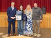 From left, LIRR President and Patchogue-Medford School District alumnus Robert Free, Oregon Middle School eighth grader Jessica Knox, health and wellness teacher Haley Wood, and Principal Bryan Lake celebrate Genesi’s winning illustration.