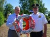 From left, Riverhead Town Supervisor Jerome Halpin and Riverhead Chief of Police Edward Frost showcase the decorated life ring presented to the Town of Riverhead by the Riverhead High School Key Club.