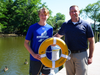 From left, Riverhead High School Key Club member Grady Moore and his father, Key Club advisor Garrett Moore, hold one of the life rings installed at Grangebel Park.