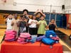 Uniondale School District Superintendent Dr. Monique Darrisaw-Akil, middle, and Uniondale students show off “U” symbols to proudly represent the District at the My Brother’s Keeper back-to-school drive.