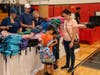 Uniondale students excitedly receive new backpacks at the My Brother’s Keeper back-to-school drive.