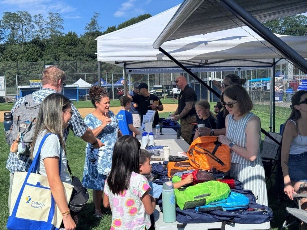 Port Washington Police District officers and staff give backpacks and school supplies away to local residents at National Night Out 2026.