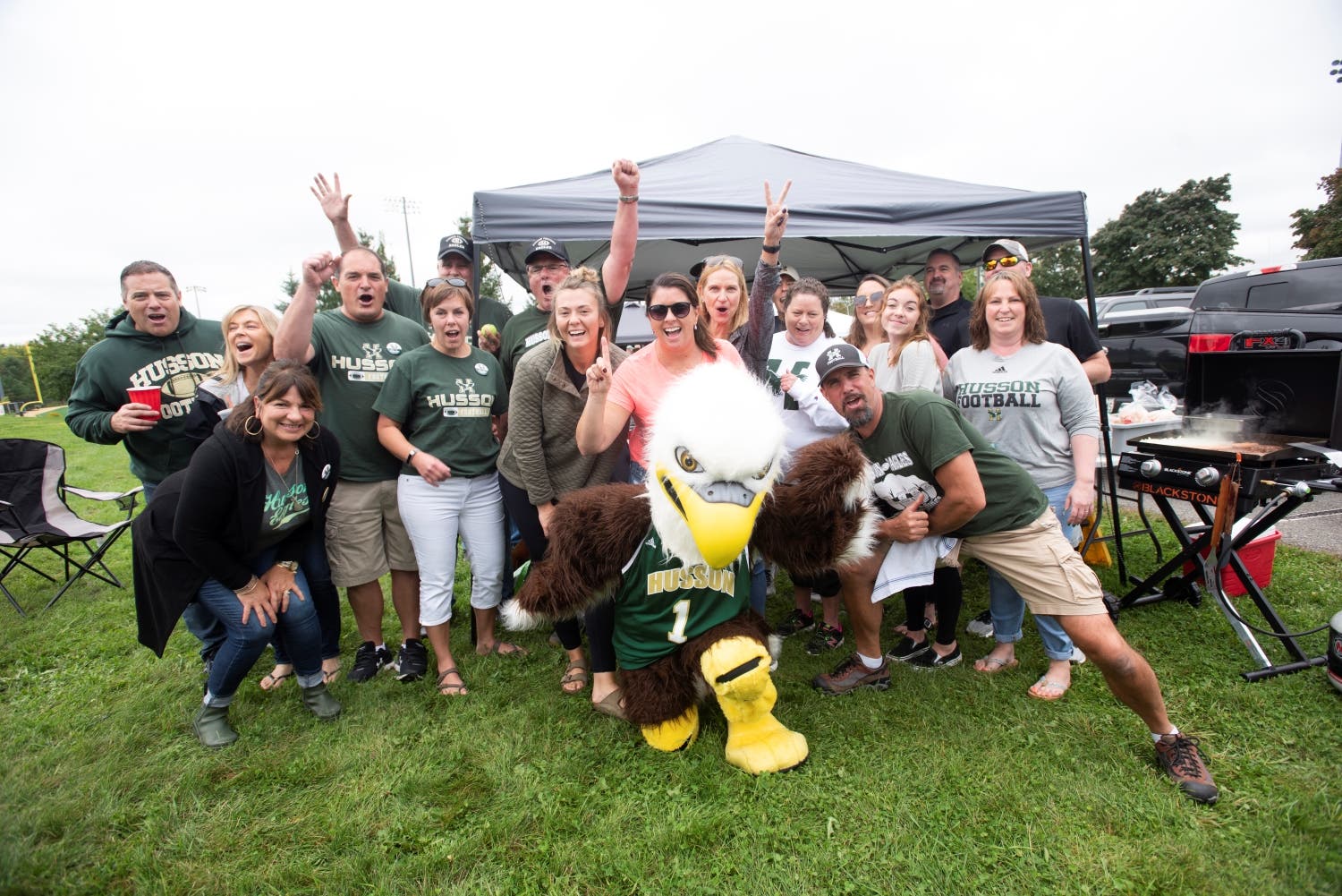 Husson alumni and the University's mascot Baldwin the bald eagle.