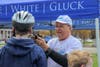 Attorney David W. White of Breakstone, White & Gluck fits a bicycle helmet donated by the Boston firm's Project KidSafe.