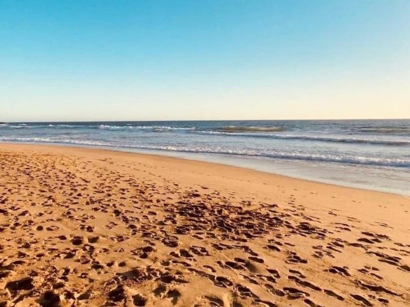 A beach in Montara under clear blue skies.  