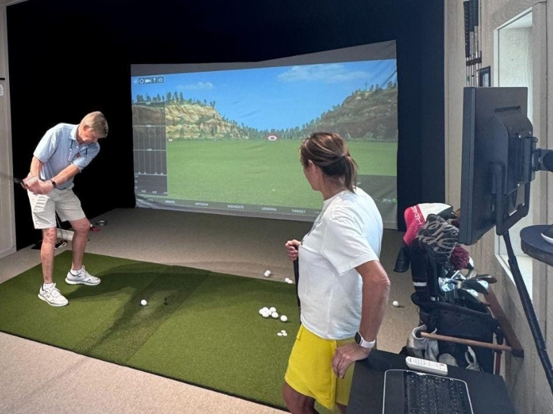 Jenner’s Pond resident Newt Brosius celebrates the opening of its new Virtual Golf Center, where residents can tee off on more than 80 courses from around the country and enjoy golf year-round. 
