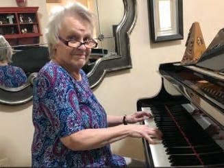 Judy Schmid plays the piano in her apartment at Eagle’s Trace. Judy chose to move to Eagle’s Trace inpart because her good friend Carole Payne lives at the West Houston community and enjoys the lifestyle.