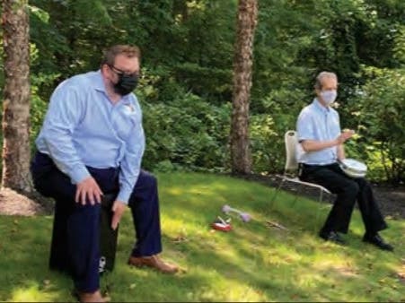 Rev. Chad Kidd, left, pastoral ministries manager, and Rev. Marcus Lisle lead a drum circle with safe social distancing measures at Brooksby Village.