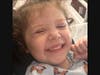 Oaklyn being brave and giving her mom a big smile as she gets ready for treatment at Robert H. Lurie Comprehensive Center in Chicago.